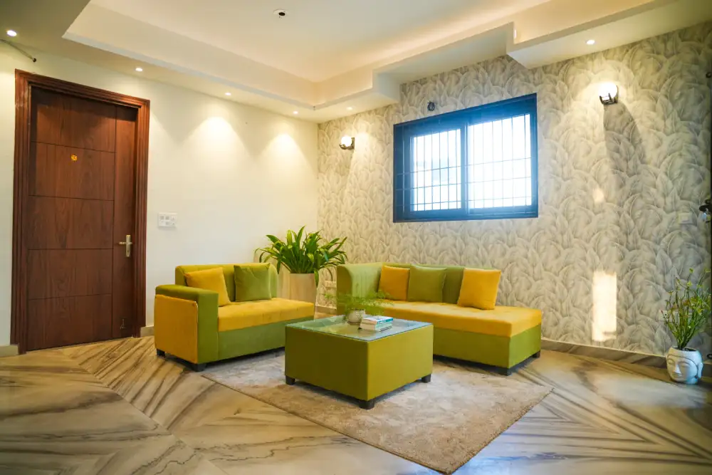 Resident lounge with sofas and indoor plants at Panaah Rehabilitation Centre